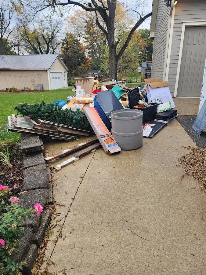 Dumpster being loaded with debris for Roofing Dumpster Rental in Ludlow